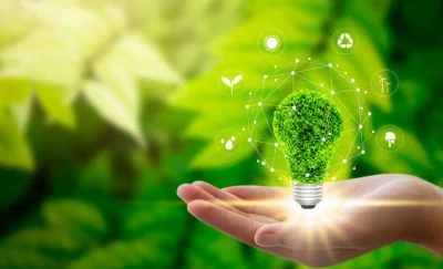 Hand holding a green eco friendly lightbulb